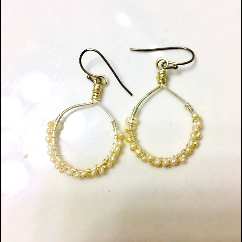 Silver hoops with pearl beads.